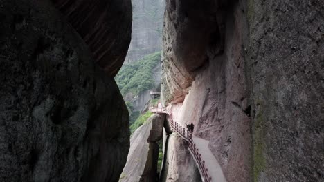 Aerial:-scenic-hike-on-Bajiao-Shan-mountainside-cave,-China