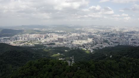 Chinese-city-Guangzhou-viewed-from-Bajiao-Shan-mountain,-4K-aerial-view