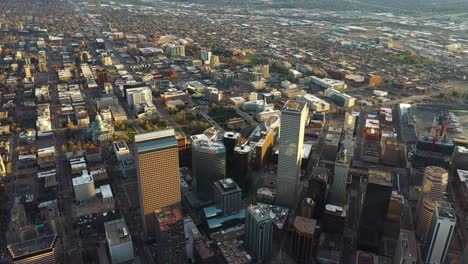 Aerial-View,-Downtown-Denver,-Colorado-USA,-Skyscrapers-in-Financial-Center-and-Neighborhood-on-Golden-Hour-Sunset-Sunlight,-Drone-Shot