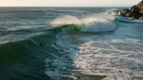 Aerial-of-a-surfer-in-Lladudno-catchting-a-big-wave-and-crashes-in-Cape-Town,-South-Africa