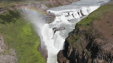 Sunny-day-at-Gullfoss-waterfall-in-Iceland,-water-mist-creating-rainbow