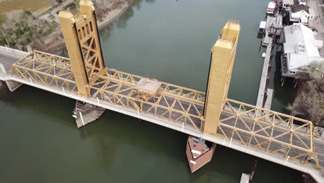 Aerial-view-overlooking-the-Sacramento-tower-bridge,-in-sunny-California,-USA---tilt,-drone-shot