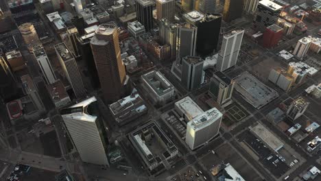 Aerial-View-of-Downtown-Denver,-Central-Financial-District,-Modern-Skyscrapers-on-Sunset-Sunlight,-Revealing-Tilt-Up-Drone-Shot