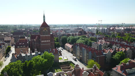 Aerial---flying-over-Gdansk-Old-Town-buildings---Church-of-Sts