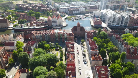 Pull-out-aerial-over-the-historic-old-town-of-Gdansk-Poland---New-meets-old-architecture