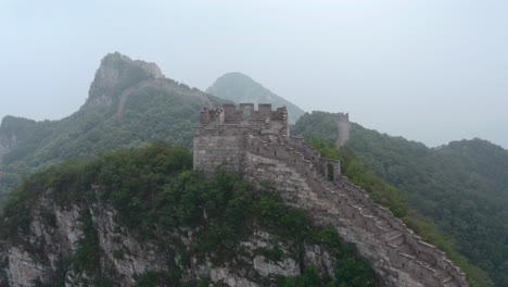 Fly-over-the-mountain-ridge-with-old-part-Great-Wall-of-China-on-top