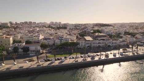 Riverside-promenade-against-Lagos,-Algarve,-cityscape-on-sunny-day