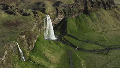 Former-ancient-coastline-of-Iceland-with-Seljalandsfoss-waterfall,-aerial