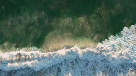 Beautiful-drone-shot-showing-a-big-wave-breaking-with-sunset-in-Llandudno,-Cape-Town