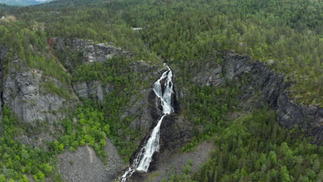 Aerial-view-around-the-Gloppefossen-falls,-in-Norway---circling,-tilt,-drone-shot