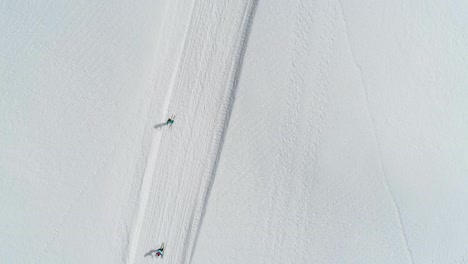 Aerial-top-down-showing-group-of-friends-cross-country-skiing-in-jura-mountains-,France---Valley-Combe-a-la-Chèvre
