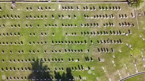 Aerial-view-over-a-cemetery,-in-the-neighborhoods-of-Los-Angeles,-California,-USA---tilt,-drone-shot