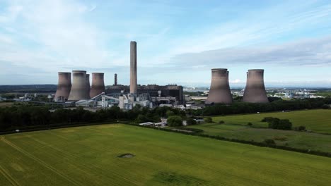 Fiddlers-ferry-power-station-aerial-ascending-up-view-cooling-towers-across-agricultural-farmland-crops