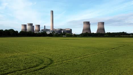 Fiddlers-ferry-power-station-aerial-view-cooling-towers-across-agricultural-farmland-rising-from-crops