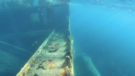 Diver-point-of-view-of-underwater-sunken-boat-shipwreck