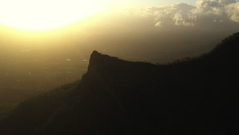 Wide-aerial-shot-at-sunset-of-the-Pinnacle-Point-mountain-at-Border-Ranges-National-Park,-New-South-Wales-in-Australia