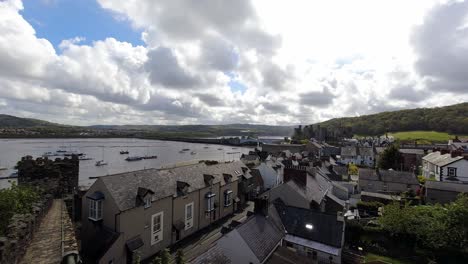 Scenic-cloudy-time-lapse-residential-houses-inside-Conwy-medieval-castle-battlement-walls-in-touristic-North-Wales