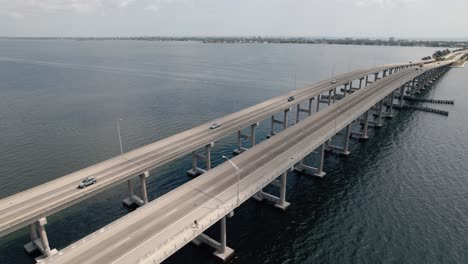 Aerial-shot-flying-over-traffic-on-a-coastal-causeway-in-Melbourne-Florida