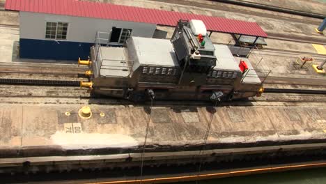 Starboard-side-Locomotive-slowly-pulling-the-ship-at-Pedro-Miguel-Locks,-Panama-Canal