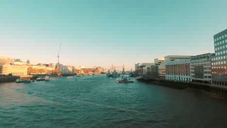 London---Thames-river-cruises-against-Tower-bridge-on-sunny-day