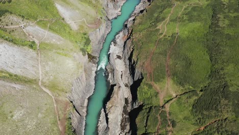 Above-spectacular-ravine-with-blue-river-in-Iceland,-aerial-at-Studlagil