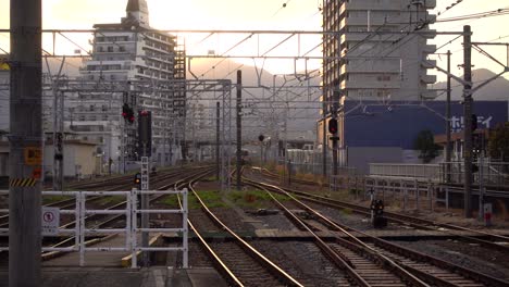 Urban-scenery-at-train-tracks-with-sunset-in-background