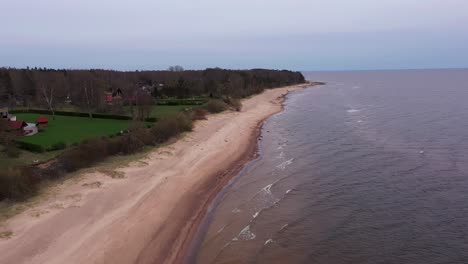 Peaceful-seaside-properties-on-beach,-aerial-dolly-in-drone-shot