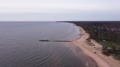 Baltic-sea-coastline-with-mole-and-sandy-beach-in-aerial-drone-view