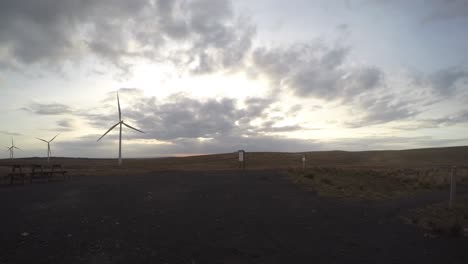 Nightfall-Windfarm-Timelapse-With-Silhouettes-Of-People-Passing-By