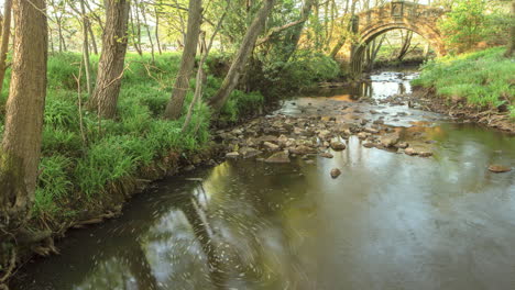 Westerdale-Motion-Timelapse,-River-with-whirlpool-revealing-ancient-pack-horse-bridge
