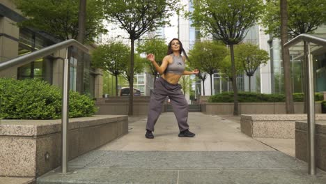 innfluential-instagram-famous-dancer-performing-her-moves-in-a-small-modern-park-outdoor-London-red-bus-passing-through-behind-her-slow-motion