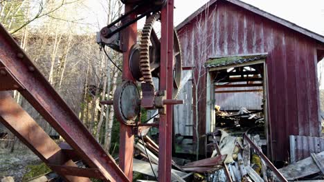 Closeup-Of-Old-Timber-Saw-Mill-Ruins,-Abandoned-Shed-And-Rotting-Junk-In-Forest