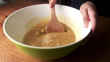 Slow-motion-closeup-of-mixing-cookie-dough-in-bowl-at-home