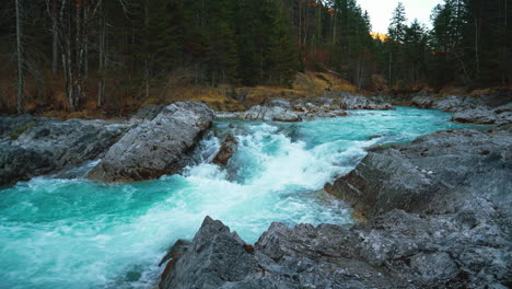 Seamless-video-loop-Cinemagraph-of-a-scenic-and-idyllic-mountain-river-waterfall-canyon-with-fresh-blue-water-in-the-Bavarian-Austrian-alps,-flowing-down-a-beautiful-forest-along-trees-and-rocks