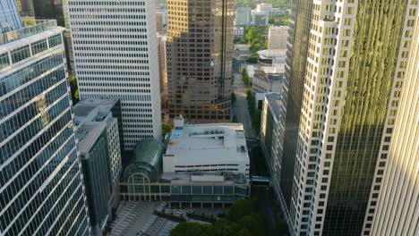 Drone-Flies-between-Corporate-Office-Buildings-in-Modern-City-at-Sunrise