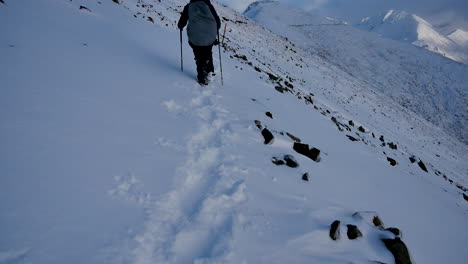 Rear-view-showing-mountaineer-hiking-on-dangerous-snowy-path-in-the-mountains-of-New-Zealand