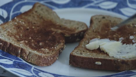 Butter-on-whole-grain-toast-on-a-plate