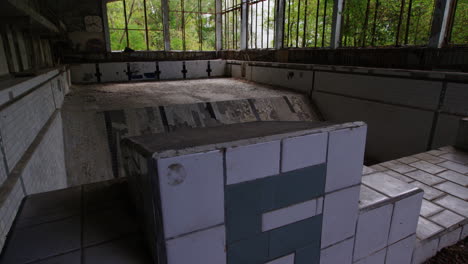 Pan-up-reveal-of-the-long-abandoned-swimming-pool-in-Prypiat-after-the-1986-Nuclear-reactor-meltdown-at-Chernobyl