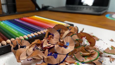 Panoramic-shot-of-a-pile-of-crayon-shavings-and-sharpened-pencils-in-the-background