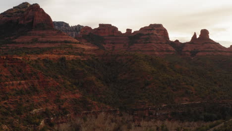 Aerial:-table-mountain-valley-with-sandstone-in-Sedona,-Arizona---drone-flying-over-forest