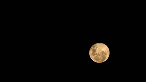 Orange-Full-moon-moonrise-time-lapse,-pitch-black,-dark-night-background