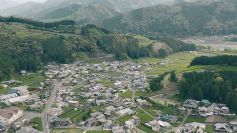 Aerial-View-Of-Village-And-Lush-Tea-Farms-Between-The-Green-Mountains-In-Kawane,-Shizuoka,-Japan