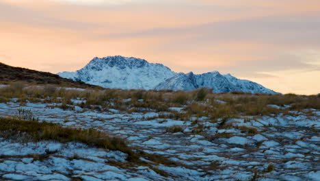 Panning-shot-of-icy-Kepler-Track-and-snow-covered-mountains-in-background-during-epic-sunset-light