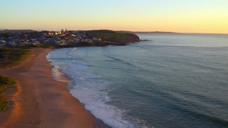 Ocean-Waves-Washing-Sandy-Shore-At-Jones-Beach-In-Kiama-Downs,-New-South-Wales,-Australia---aerial-shot