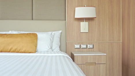 Empty-Modern-Hotel-Room-and-Bed-with-White-Linen,-Gentle-Left-Pan