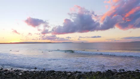 Panorama-Of-Surfers-Riding-The-Ocean-Waves-At-The-Beach-In-Noosa-National-Park-In-Australian-State-Of-Queensland