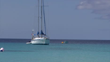 Sailboat-in-the-turquoise-waters-of-Grand-Turk-island,-Turks-and-Caicos-Islands