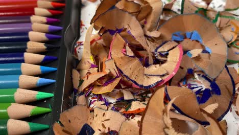 Dolly-shot-of-a-pile-of-crayon-shavings-and-sharpened-pencils