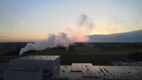 Left-pan-of-factory,-with-beautiful-sunset-in-the-background