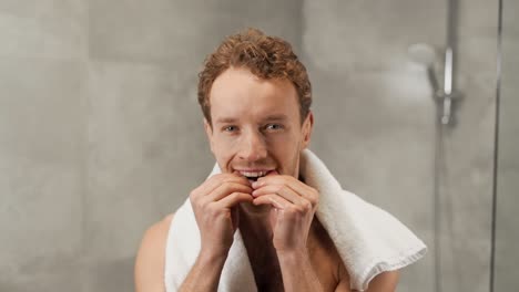 Portrait-of-a-blond-handsome-man-inserting-dental-clips